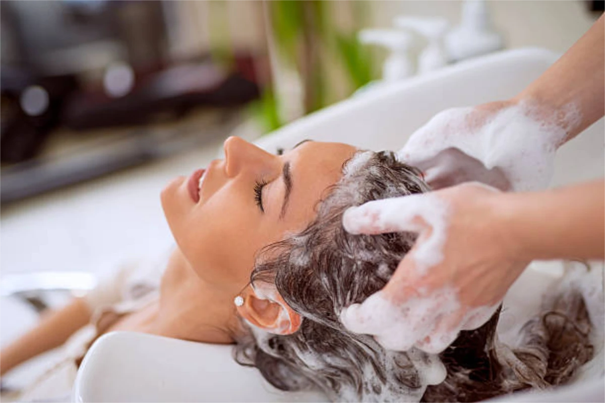 A woman having her hair shampooed at Fresh & Co. Salons